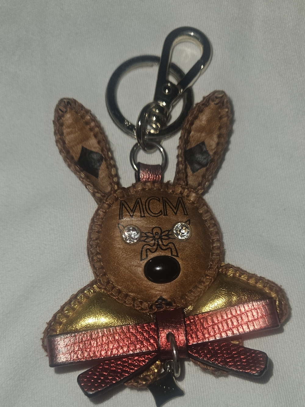 MCM Brown Leather Bag Charm with Gold Accents and Red Bow